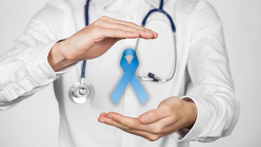 doctor holding blue ribbon as the symbol of prostate cancer